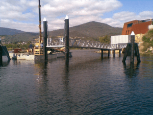 A bridge spans over water with a boat floating beneath it.